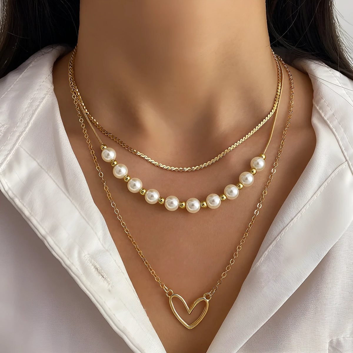 Vintage gold necklace with double heart pendant on textured pearl chain