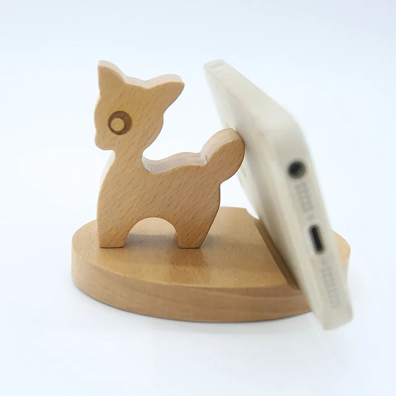 Solid beech wood mobile phone stand with a decorative resin animal ornament and a coin slot.