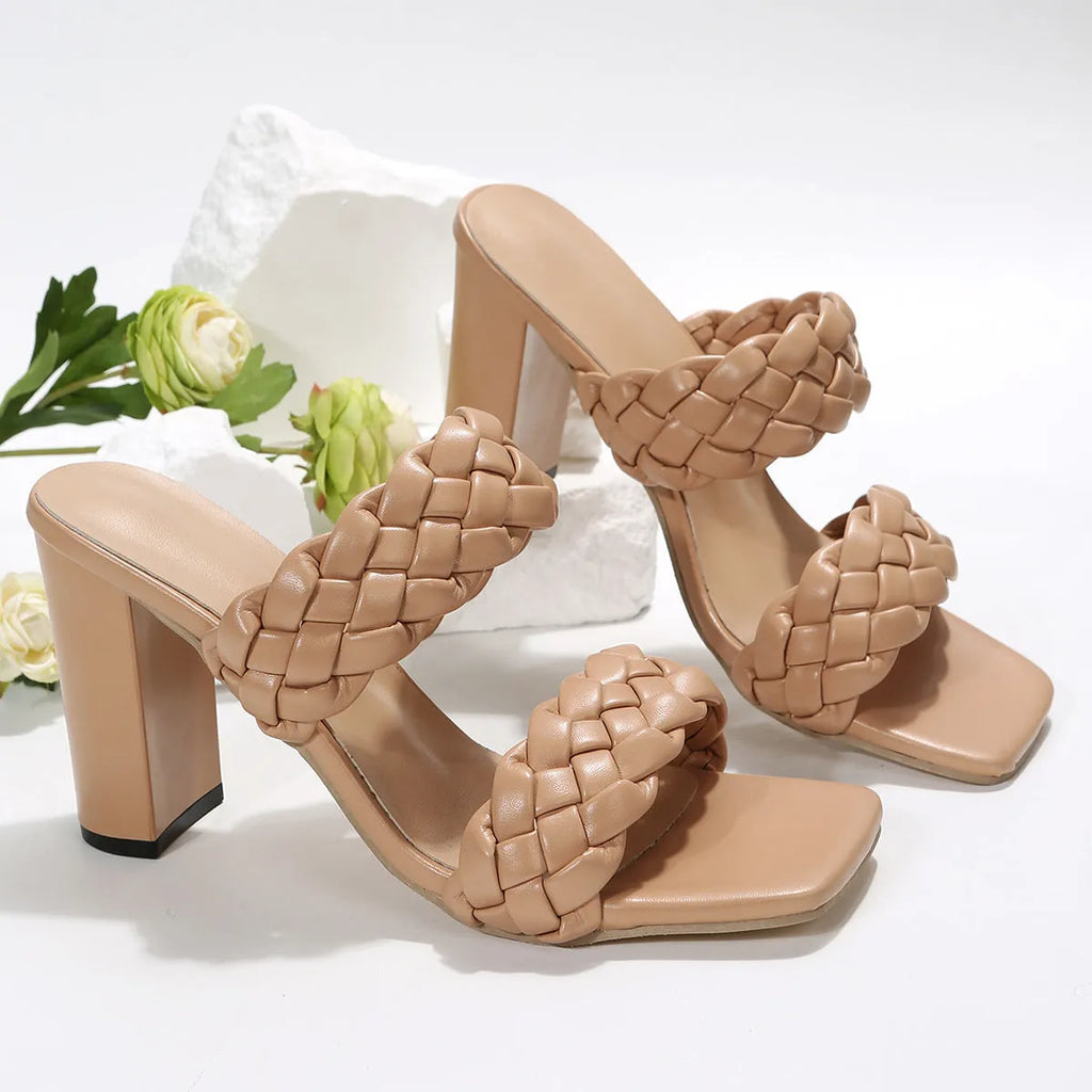 White square toe flip-flops with chunky woven heel and twisted strap design on a plain background.