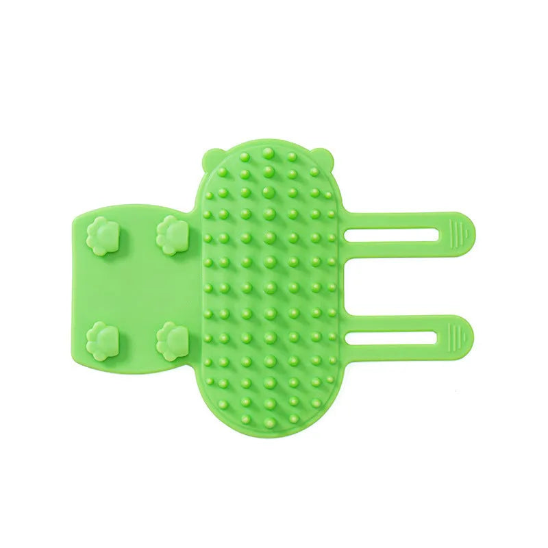 Adjustable silicone cat scratching grooming brush in black, mounted on a table leg.