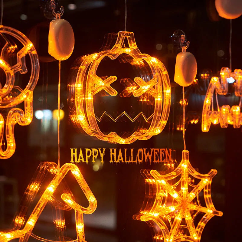 Halloween battery-powered LED window lights with suction cups showing spider, pumpkin and ghost designs