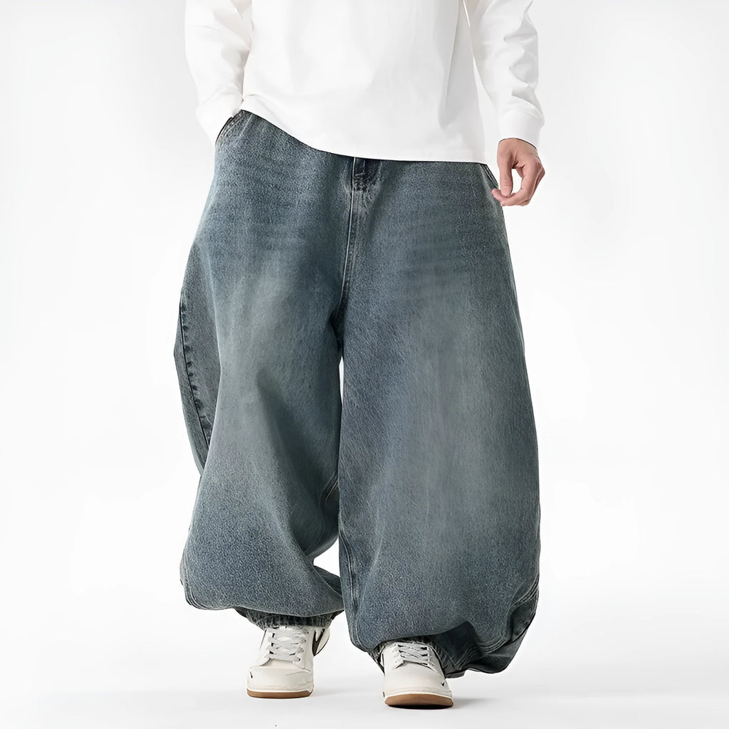 Men's plus size baggy jeans in dark blue denim with a straight leg opening and low waist.