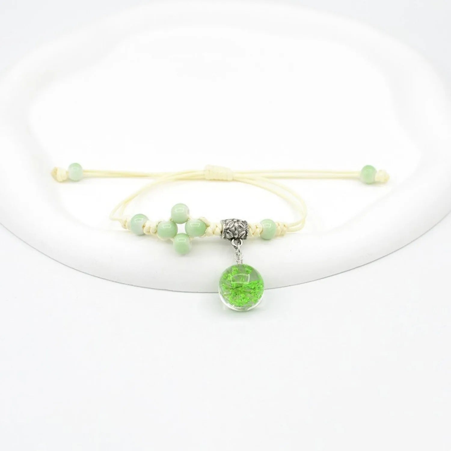 Women's hand-woven glass bracelet with large 1.4cm beads containing dried flowers, shown in blue colour option