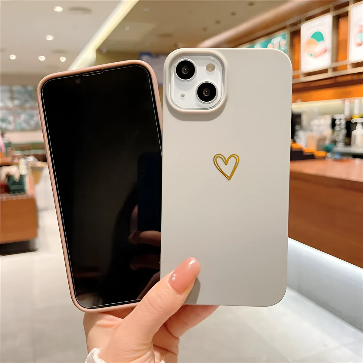 Soft grey silicone iPhone case with a hot stamped Love design, shown fitted on a phone.