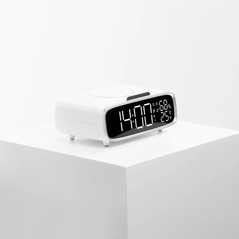 White compact Bluetooth speaker with integrated wireless charging pad and night light on a table