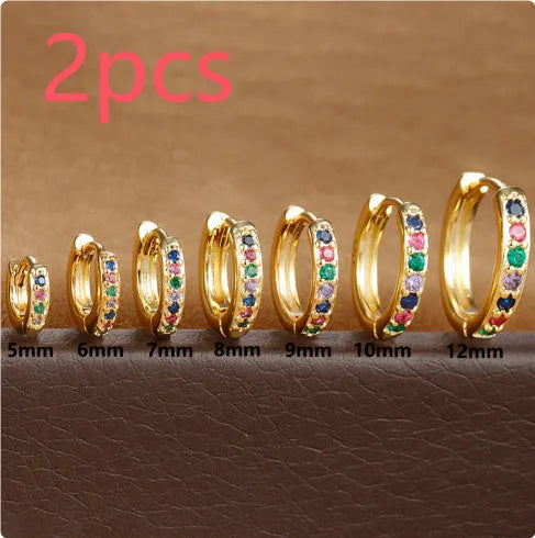 Set of three pairs of round zircon stud earrings showing gold colour, rose gold colour, and silver colour finishes.