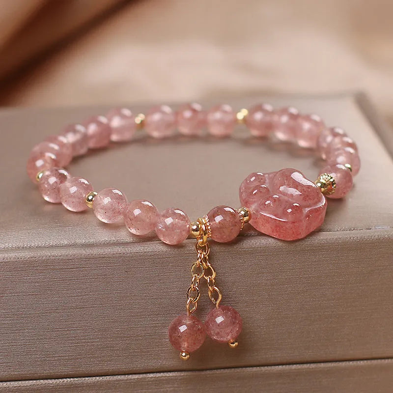 Double-layer strawberry quartz bracelet with lucky cat charm and red cat's eye flowers on adjustable fastening