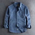 Men's light blue cotton long sleeve shirt in a cardigan style on a hanger.