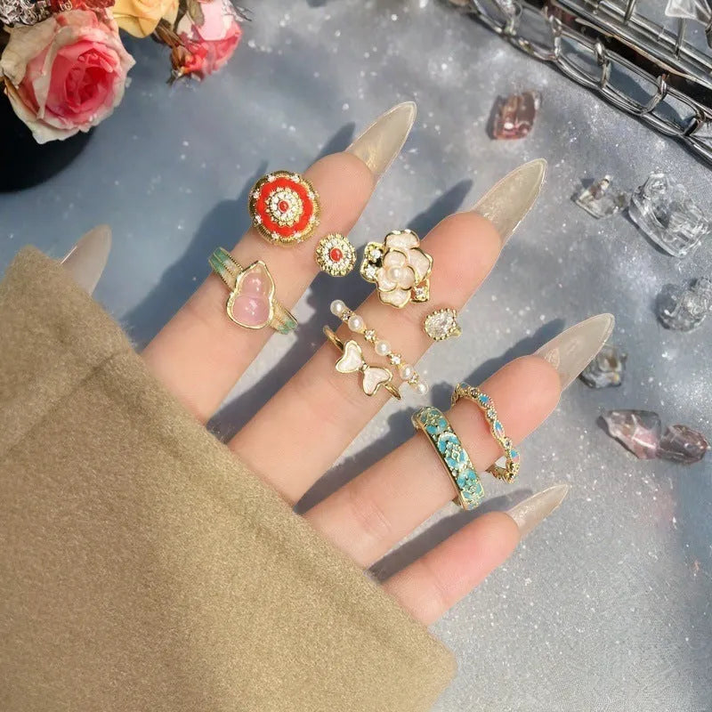 Adjustable copper ring featuring a gourd, flower, and bow design with zircon inlay in New Chinese style.