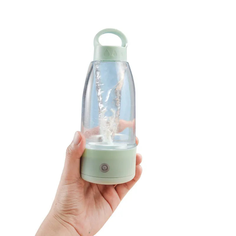 Automatic electric shaker bottle with USB port, handle, and blending motor in green, pink or white.