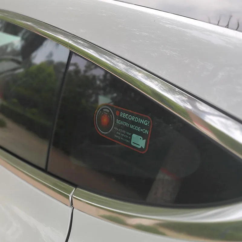 Pair of white electrostatic warning stickers for Tesla Sentry Mode, sized 11x5 cm.