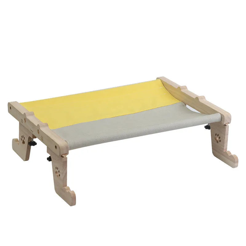 Wooden cat hanging bed with fabric hammock installed on balcony railing