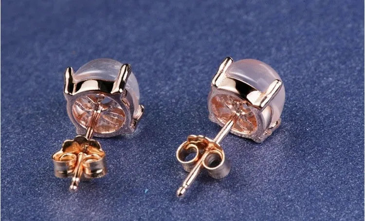 Close-up of women's drop-shaped synthetic quartz stud earrings with a rose gold finish.