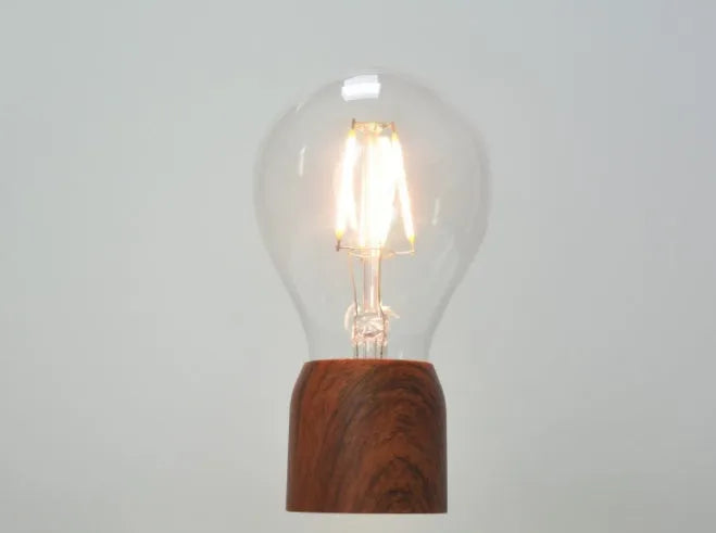 Magnetic levitation floating bulb lamp with glass bulb and imitation wood base