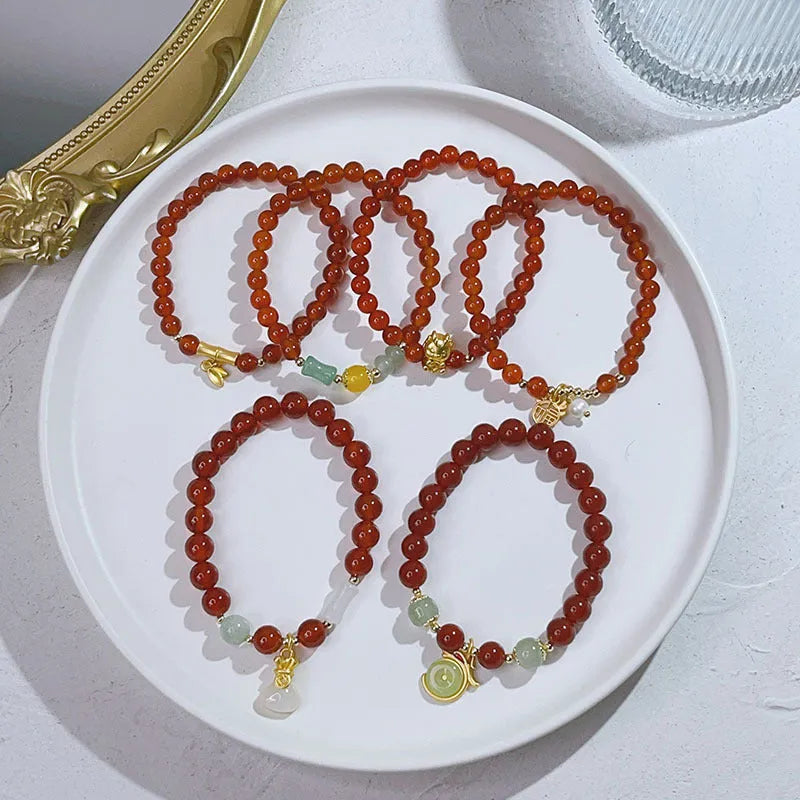 Women's red agate bracelet with Chinese dragon design, a handcrafted gift for Bamboo Festival.