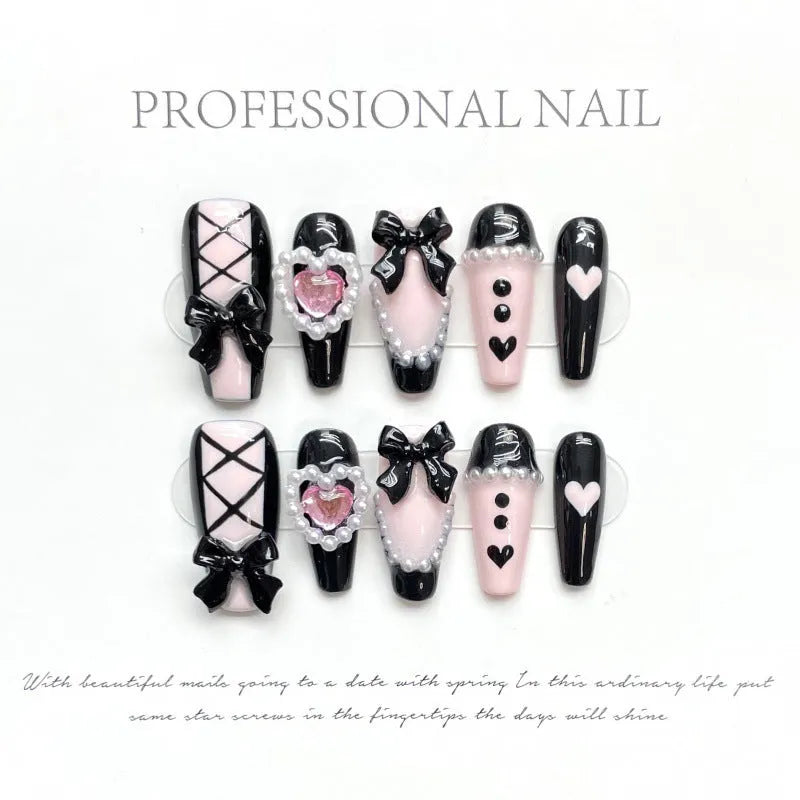 Black detachable manicure set with hand-painted pink hearts and bow patterns in cat eye style