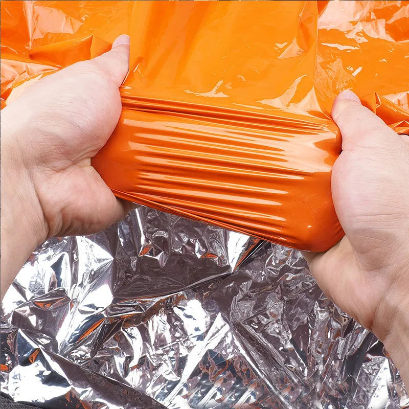 Portable emergency sleeping bag, blanket, and tent in green or orange, thermal and waterproof for camping and survival