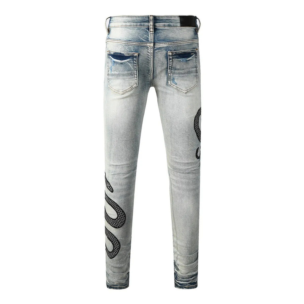 Distressed blue skinny jeans with tapered leg and button fly closure on mid-waist design