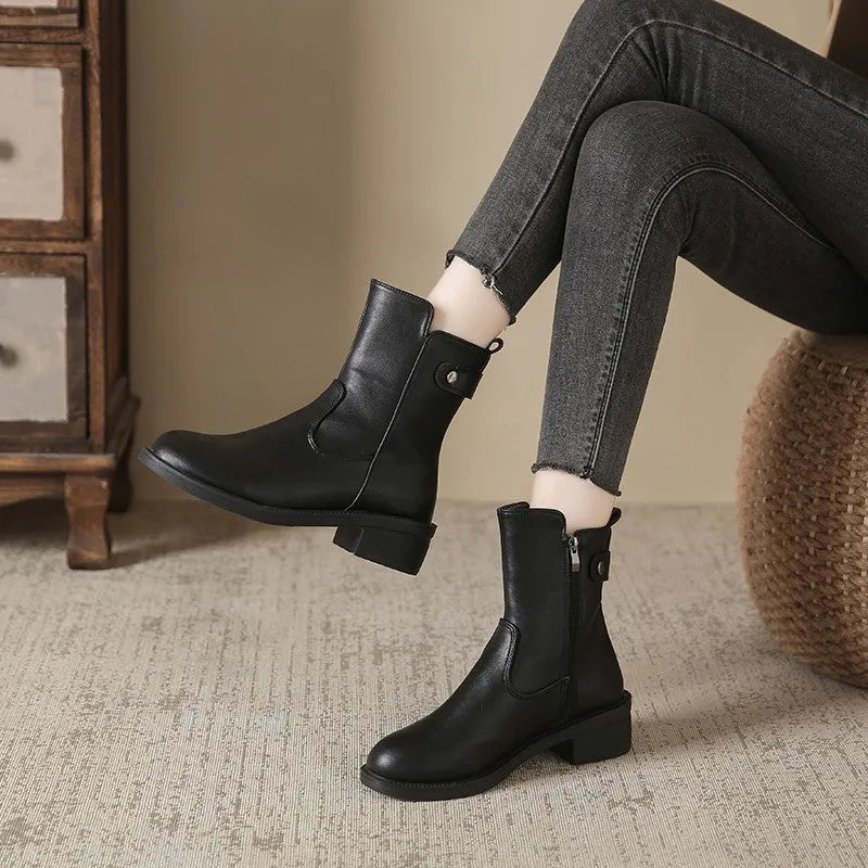 Black women's low heel ankle boots with a side zip and round toe.
