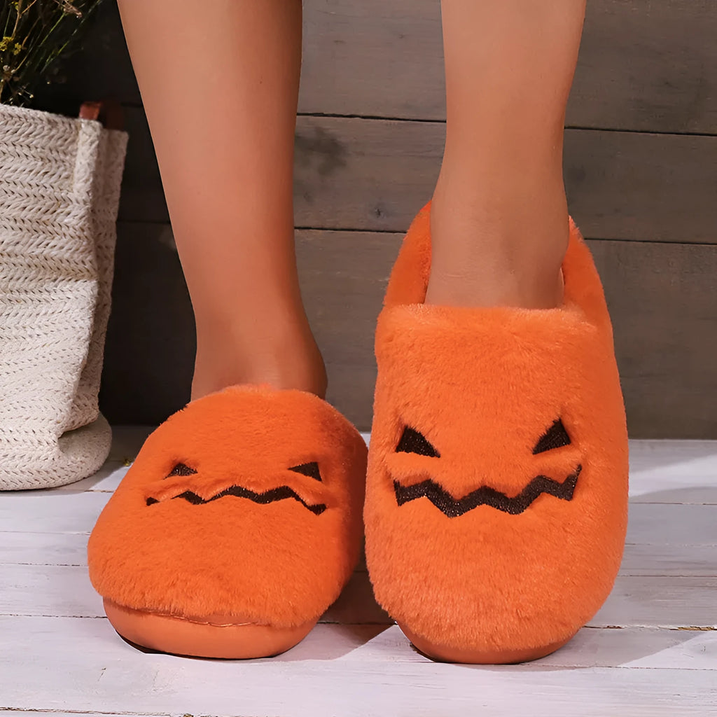 Orange Halloween pumpkin-themed plush slippers with a coral velvet upper and non-slip sole.