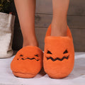 Orange Halloween pumpkin-themed plush slippers with a coral velvet upper and non-slip sole.