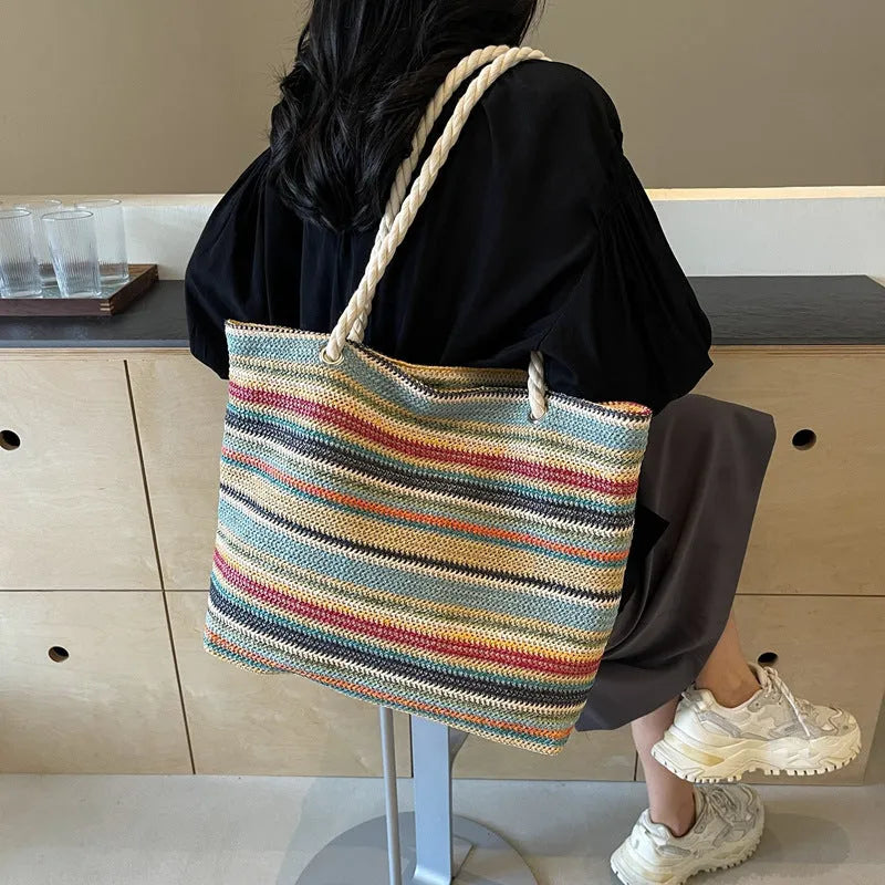 Blue nylon woven shoulder bag with large capacity and polyester lining shown against a neutral background