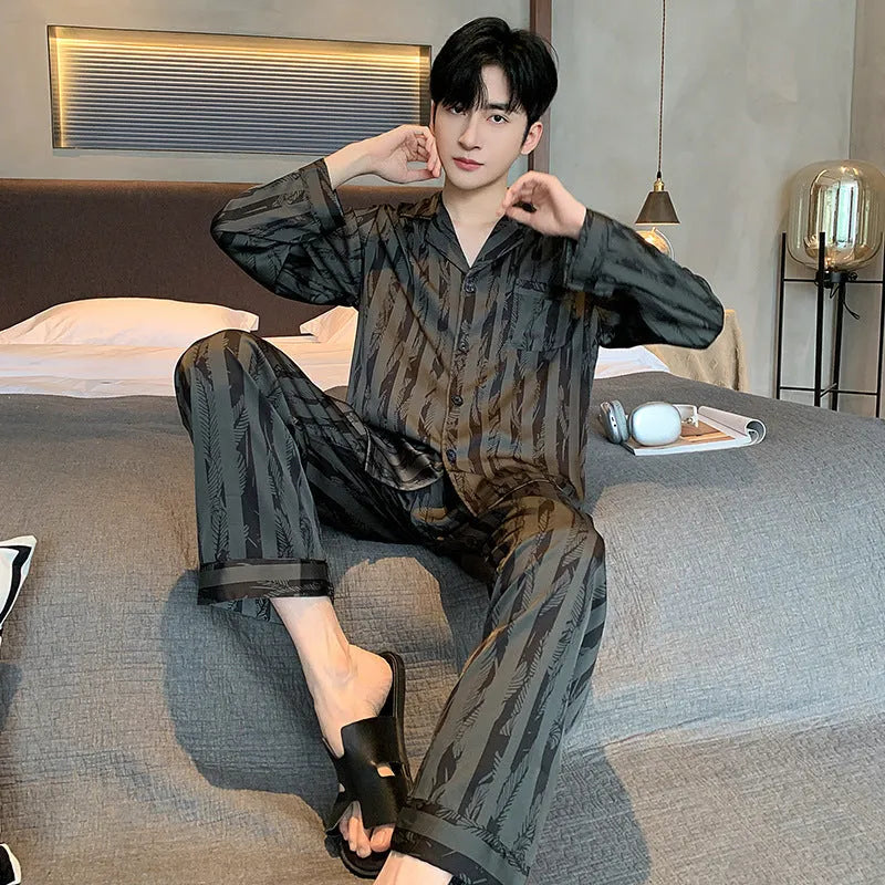 Men's black striped Ice Silk pajama set with long sleeves and trousers laid flat