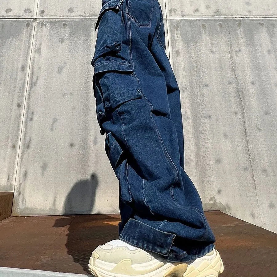 Dark blue distressed women's jeans with a high waist, wide legs, and multiple workwear-style pockets.