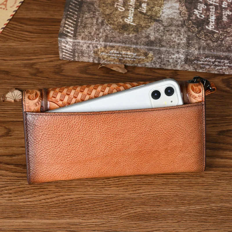 Women's brown tri-fold leather wallet with embossed floral pattern showing interior card slots
