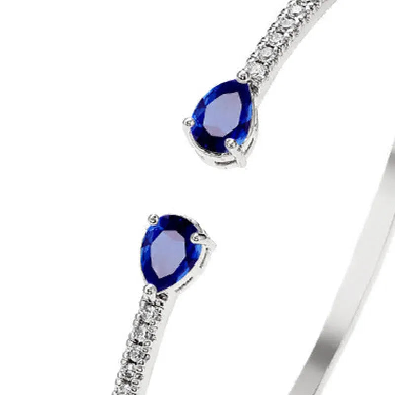 Copper bracelet with zircon inlay in simple design available in white or blue colour options