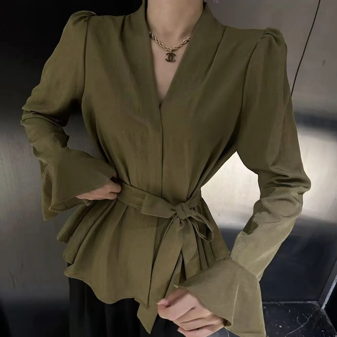 Women's black French-style shirt with irregular collar and long bell sleeves tied at waist