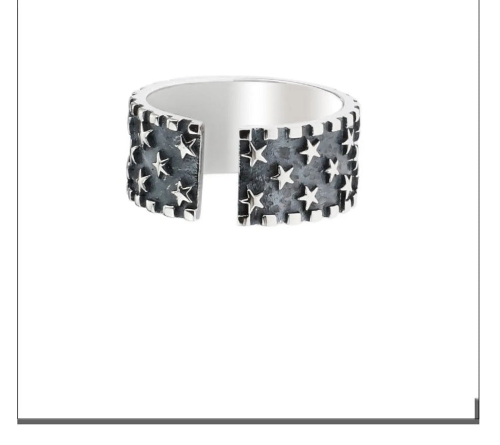 Adjustable sterling silver ring with a geometric pattern of five pointed stars on the band.