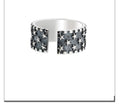 Adjustable sterling silver ring with a geometric pattern of five pointed stars on the band.