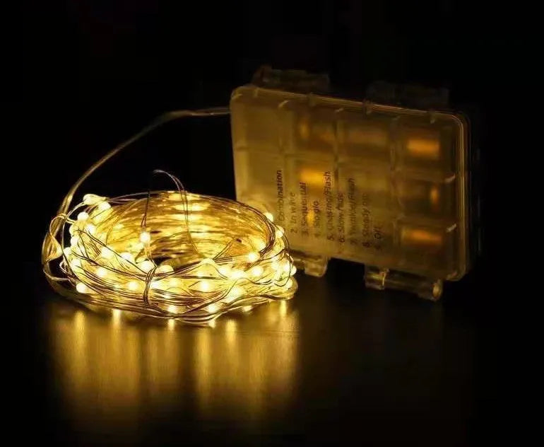 12-metre long copper wire LED string lights with small bulbs, connected to a white battery box controller.