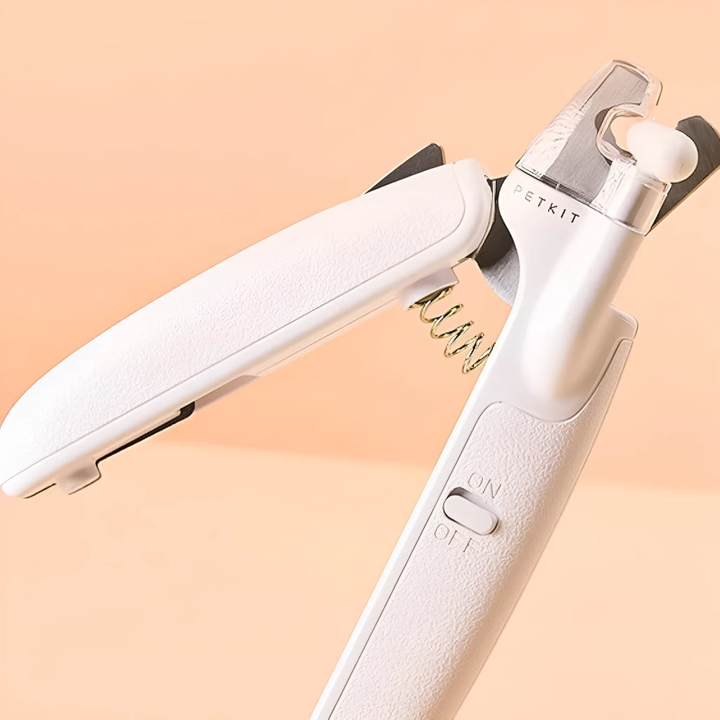White LED pet nail clipper with transparent anti-splash guard open, showing triangular stainless steel blade