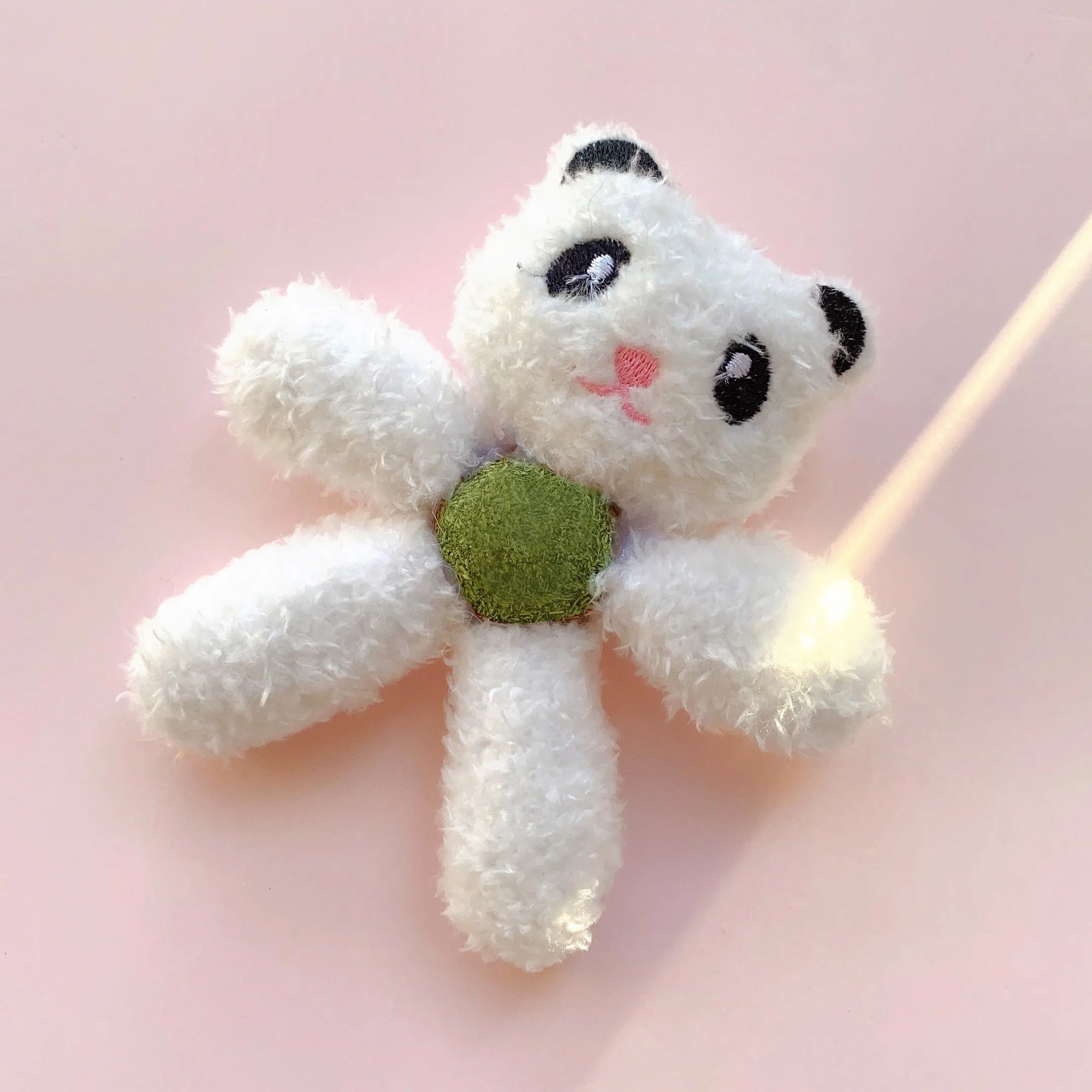 Soft stuffed catnip ball toy in animal design for chewing and play.