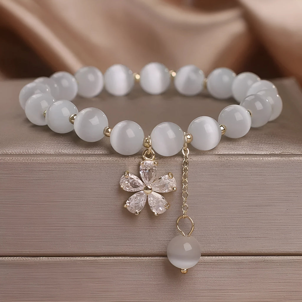 White Cat's Eye stone bracelet with flower tassel and morganite safety buckle.