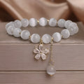 White Cat's Eye stone bracelet with flower tassel and morganite safety buckle.