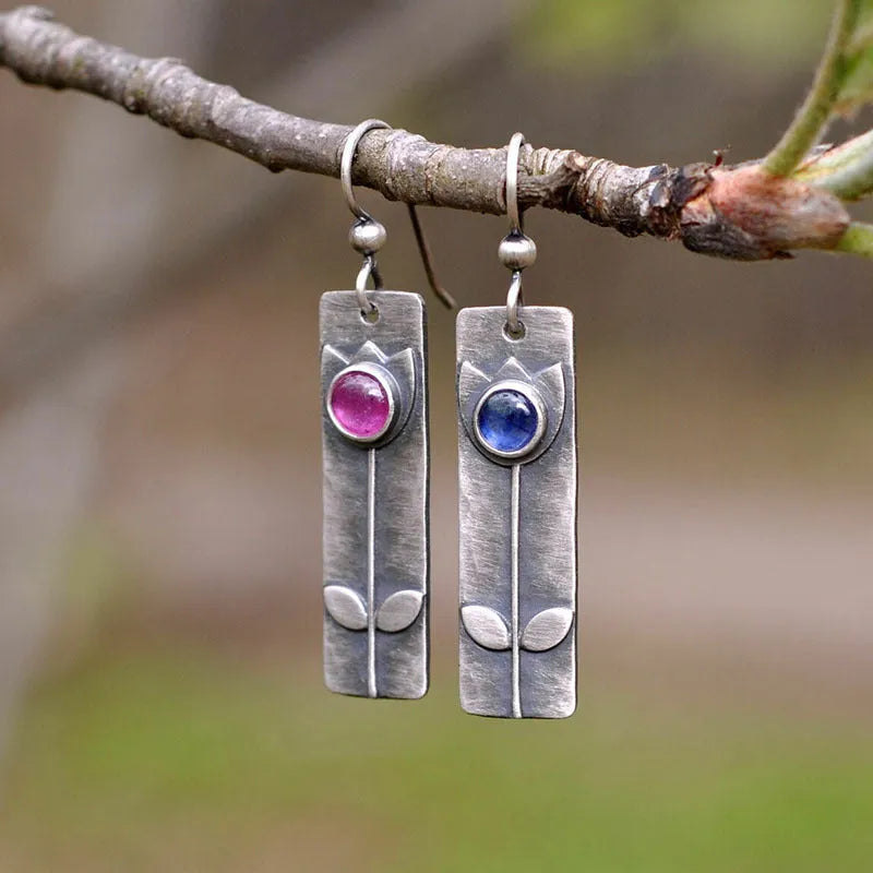 Antique finish red sapphire earrings with geometric oval shape and electroplated metal construction