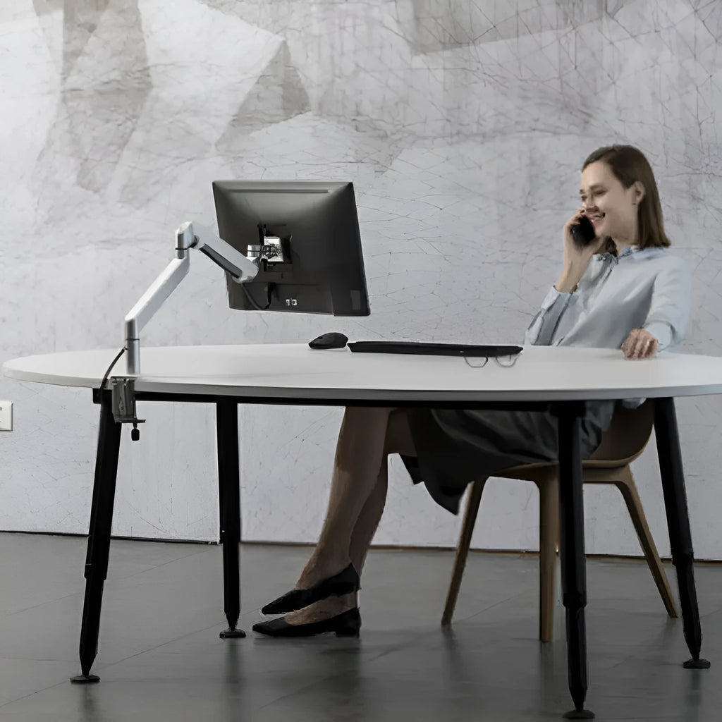 Silver aluminium laptop stand with adjustable air pressure arm bracket elevating a laptop