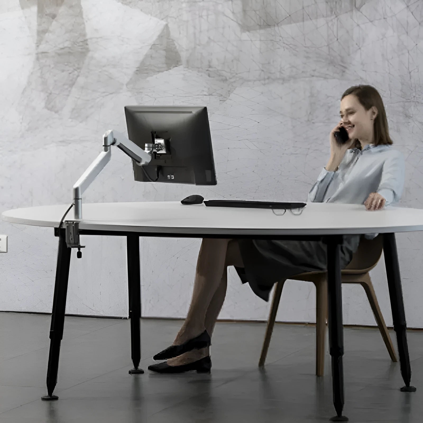 Silver aluminium laptop stand with adjustable air pressure arm bracket elevating a laptop