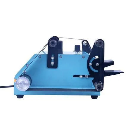 Blue desktop dual-axis belt sander with grinding belt and knife sharpening attachment on workshop bench