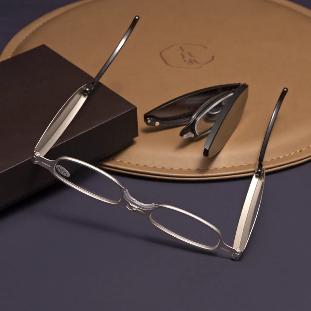 Black folding presbyopic reading glasses with retro ring temples, shown in open and closed positions.
