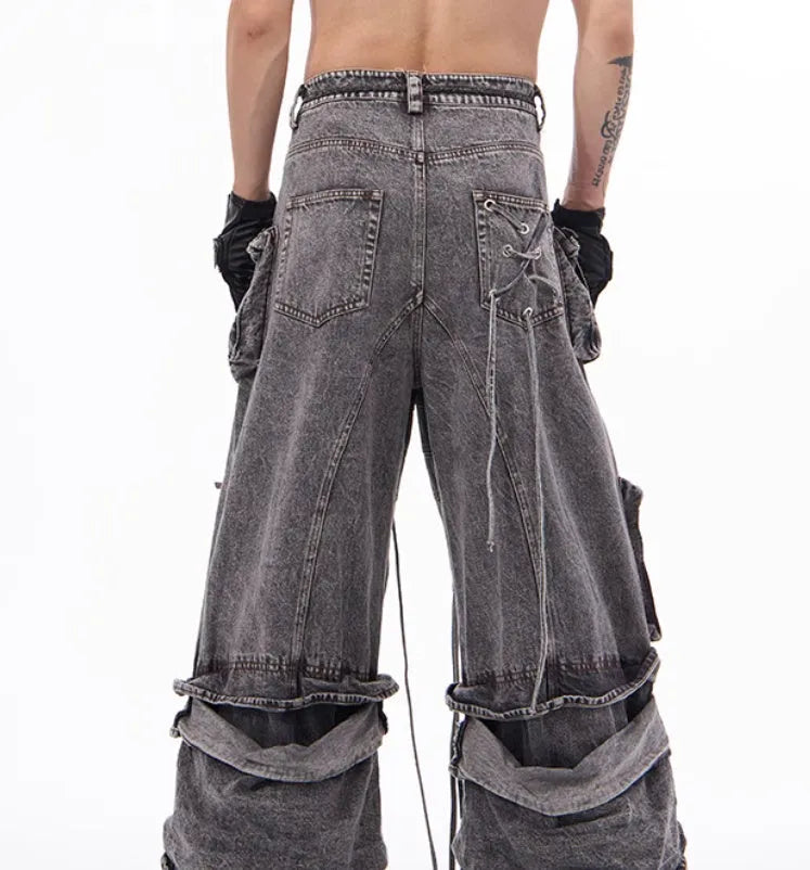 Grey distressed denim overalls with rope stitching on the legs, shown in a casual fit.