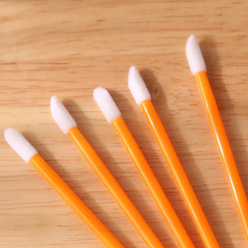 Disposable lip brushes with flocked tips and black handles in multiple colours
