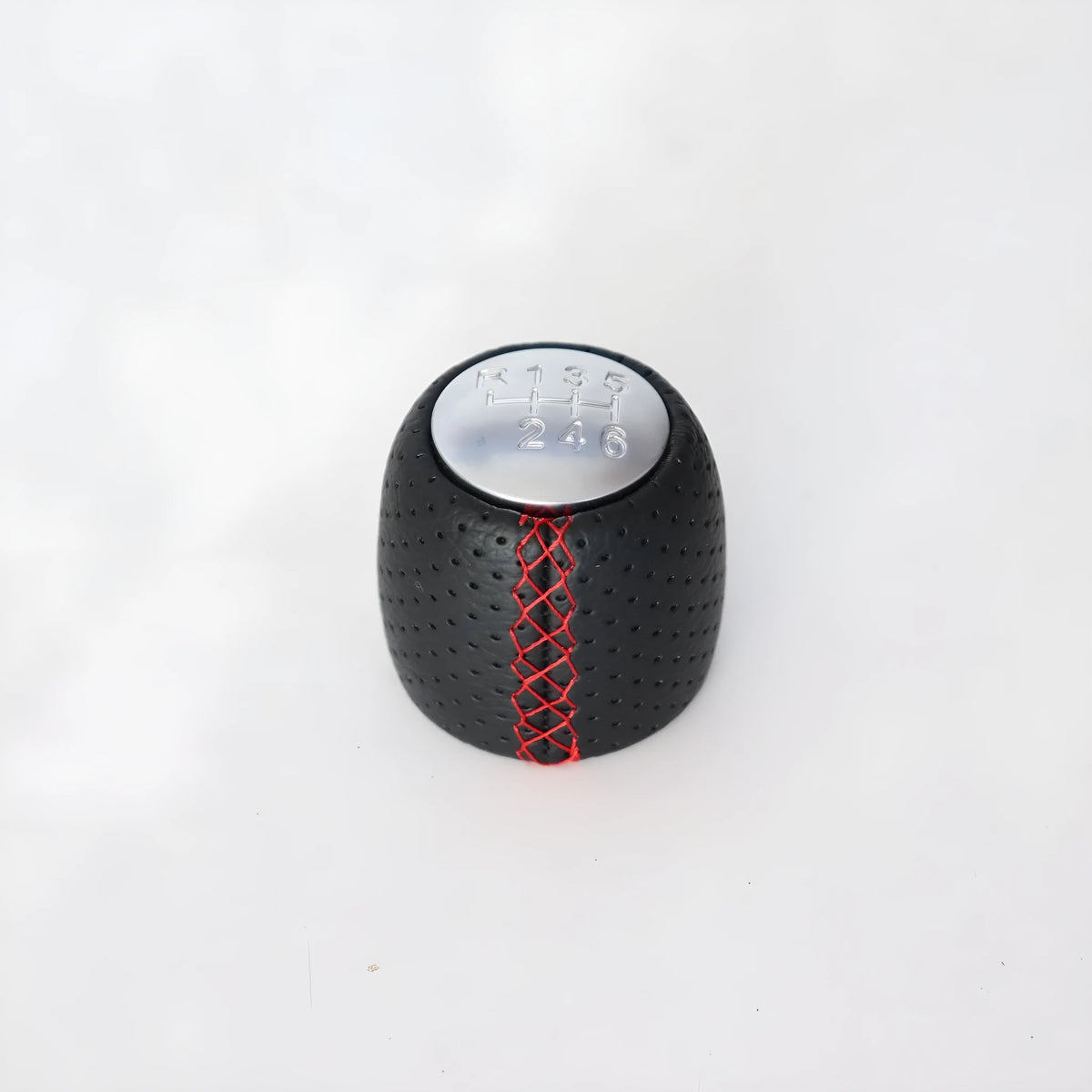 Black perforated leather-style gear shift knob for Alpha car on a 5-speed pattern matte cover.