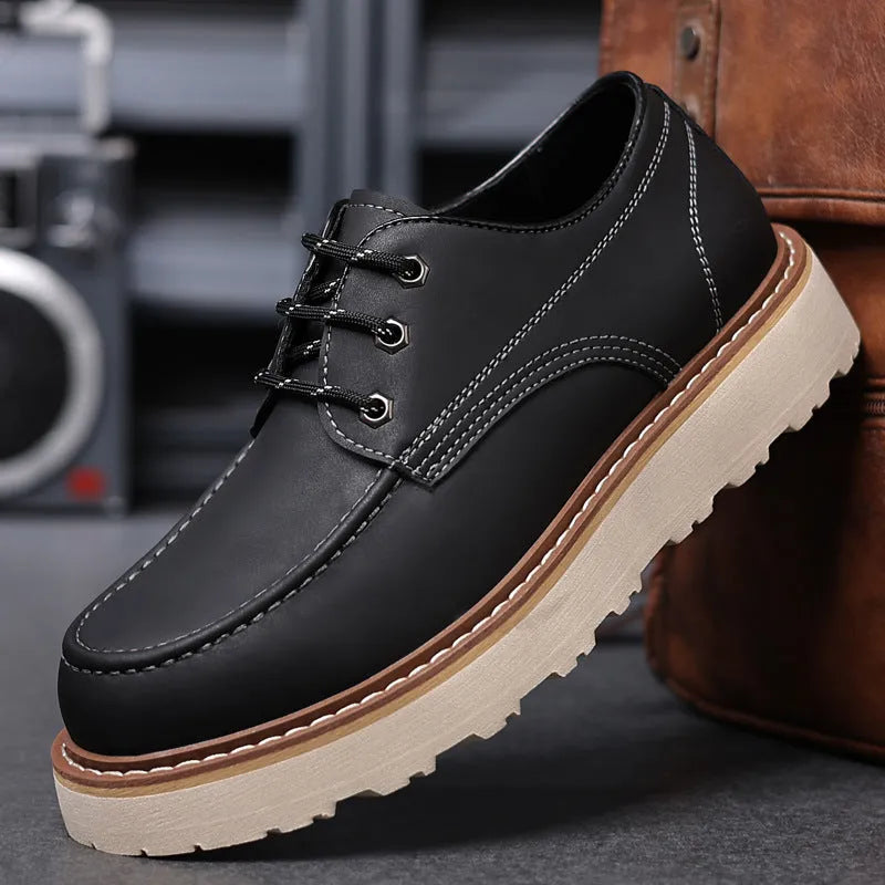 Men's black retro Martin boots with a round toe and rubber sole on a neutral background.