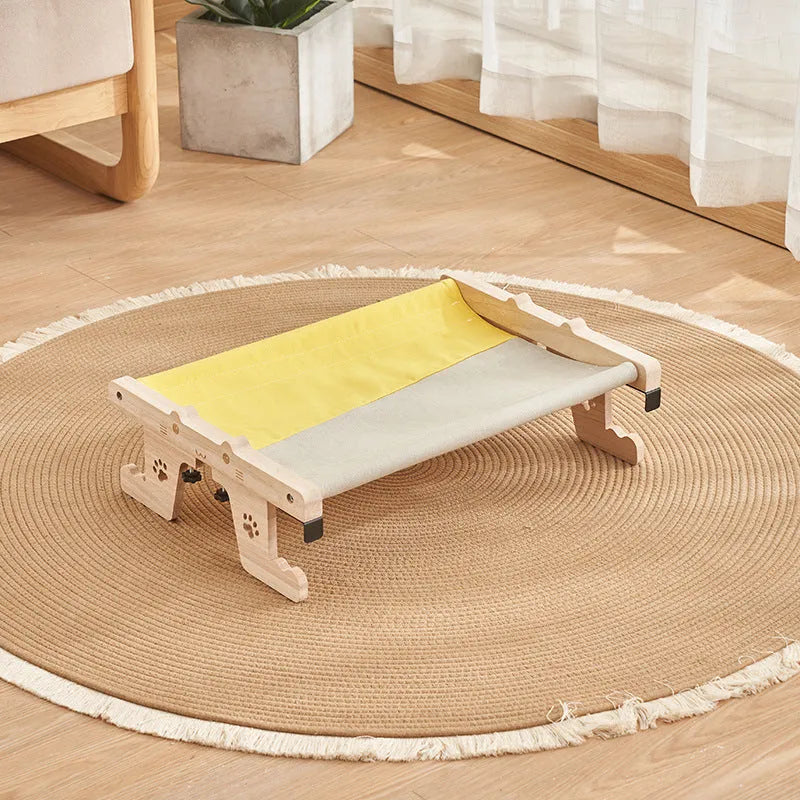 Wooden cat hanging bed with fabric hammock installed on balcony railing