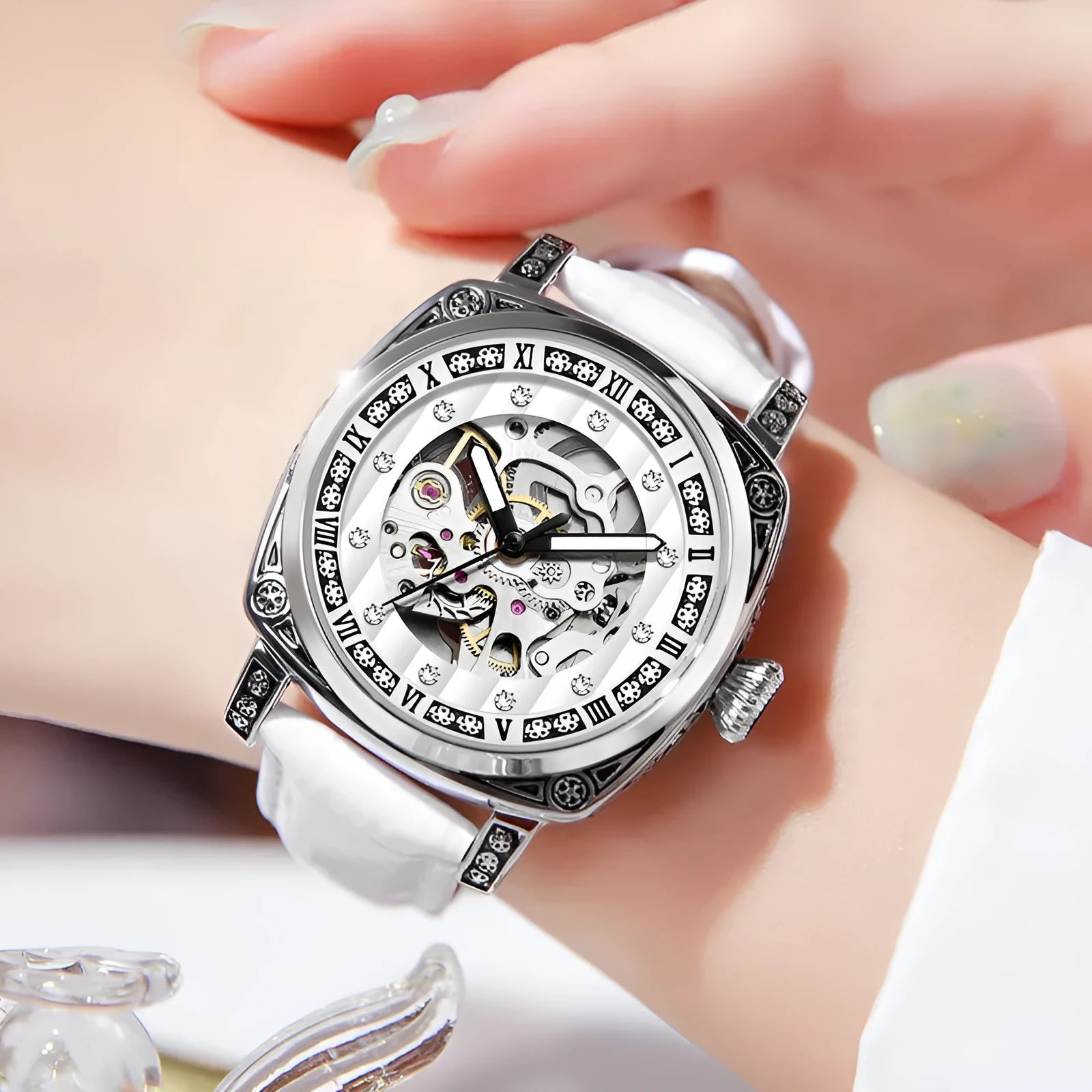 Leather strap mechanical watch with luminous hands showing 10 metre water resistance rating.