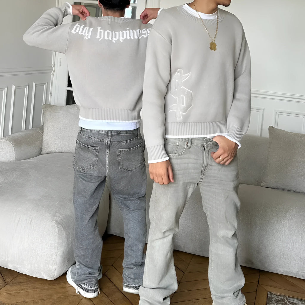 Grey loose-fitting jacquard knitwear coat with long sleeves on a hanger